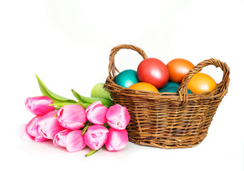 Fototapeta na wymiar Basket with Easter eggs and tulips bunch