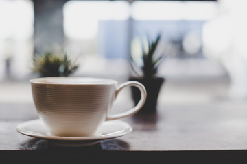 Vintage tone of hot coffee latte art in cup on table.