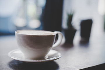Coffee cup at cafe with vintage filter.
