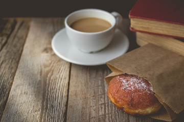 Relax time from book  with Hot Coffee and Donut on wood Backgrou