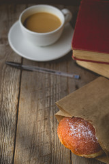 Relax time from book  with Hot Coffee and Donut on wood Backgrou