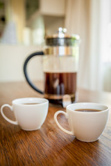 white cups and coffee plunger