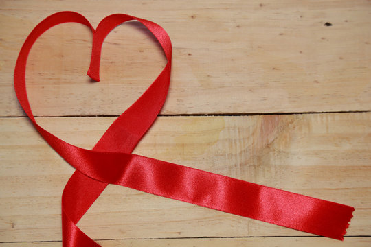 Design Red heart shaped ribbon awareness on old aged wood backgr