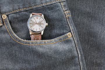 Wristwatch in denim jeans pocket