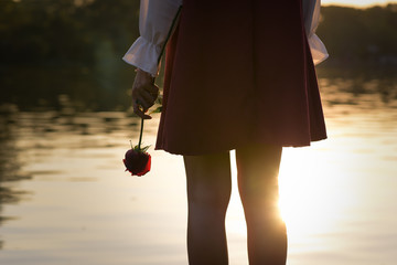 Heartbroken woman holding a rose