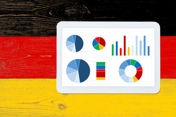 colorful dashboard over germany flag painted table