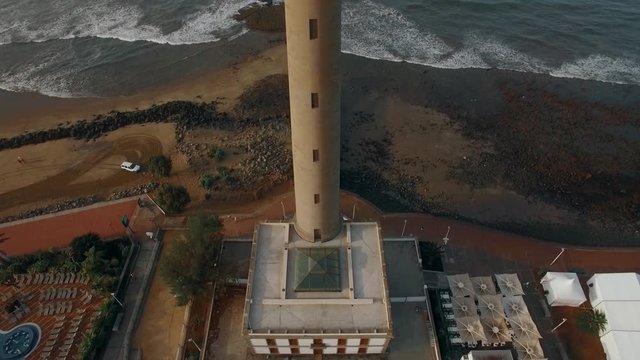 Aerial shot of Maspalomas Lighthouse on the coast of tourist town. View on ocean background, Gran Canaria