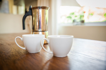 white cups and coffee plunger