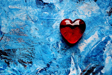 Red Glass Heart on Blue Painted Background