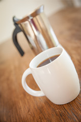 white cups and coffee plunger