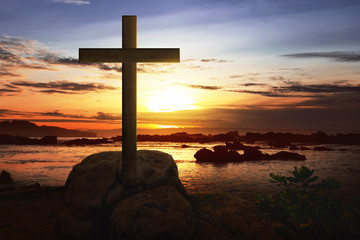 Christian cross on the rock in beach