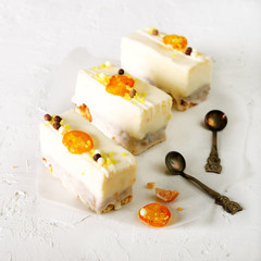 White cakes and two teaspoons for mother, woman or girlfriend on concrete background. Free space for your text.