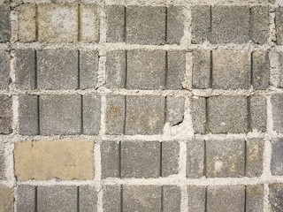 Close up old concrete block wall with gray background of cement brick wall. Surface and texture rough wall of abandoned home.