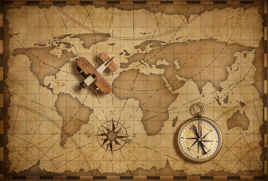 Fototapeta Mały drewniany samolot nad światową nautyczną mapą jako podróży i komunikaci pojęcie