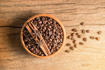 coffee bean  in wooden bowl on wood texture,top view