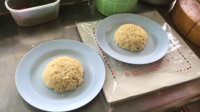 Woman Chef prepare Hainanese chicken rice for customer