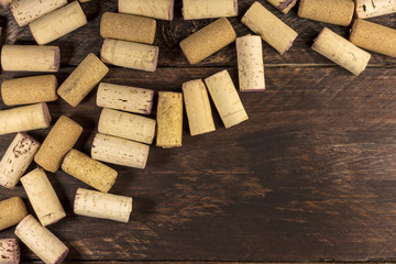 Wine corks on dark wooden texture with copyspace