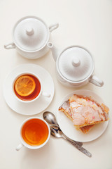 lemon cake with tea. Breakfast in bed. White background, white crockery