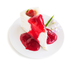 Strawberry crape cake with jam on plate