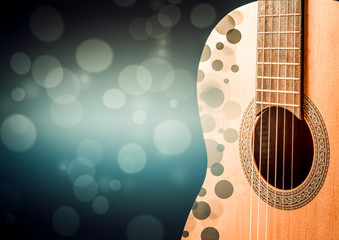 Part of a blue acoustic guitar on black background.