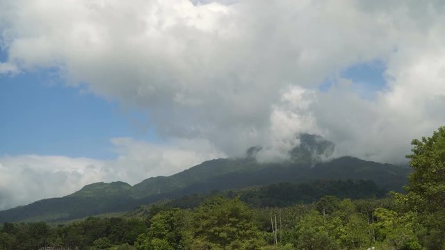 Mountains landscape, rainforest, jungle, blue sky, clouds and mist. Volcano on the island of Camiguin. Travel concept. 4K video