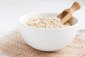 Rolled oats, porridge and cranberries for a healthy breakfast in a rustic style