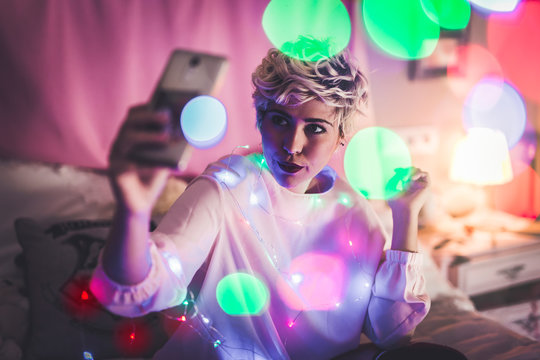 Female doing selfie with fairy lights