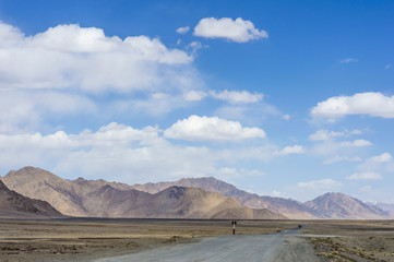 Empty dirty off road in Pamir Mountains in Gorno-Badakhshan Autonomous Region, Tajikistan