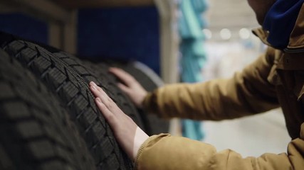 Man chosing new tires in shop