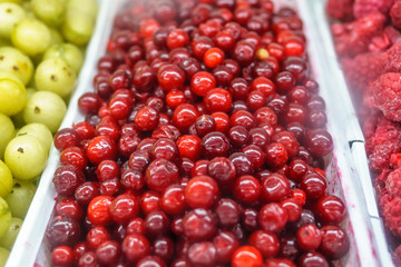 Close-up of frozen fruit in supermarket. Raspberries. cowberry, healthy food