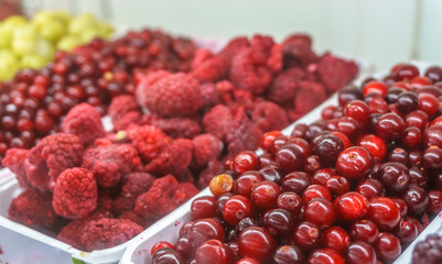 Close-up of frozen fruit in supermarket. Raspberries. cowberry, healthy food
