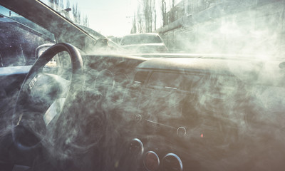 Car interior in smoke or vapour. Vape Inside car. Can be used as fire in automob