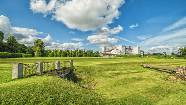 English summer panoramic landscape with small castle in background