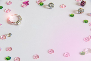 Fototapeta na wymiar Diamond ring with colorful crystal decoration, light purple background