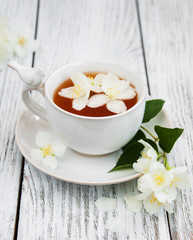 Cup of tea with jasmine flowers