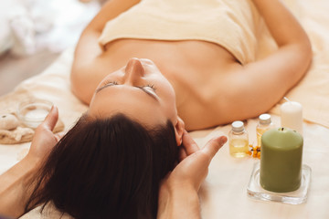 Obraz na płótnie Canvas Woman with migraine relaxing at salon free space. Brunette having treating massage. Alternative medicine, health care, headache concept