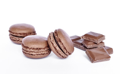 Delicious brown colored macaroons, isolated on white background. Studio isolated chocolate macaroon candy with chocolate pieces.