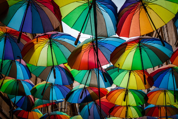 Fototapeta na wymiar Color picture of colorful umbrella roof between buildings
