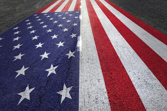 United states of america flag painted on straight aphalt road floor.