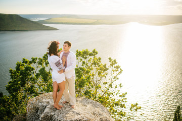 Couple wearing on dress with a pattern at beautiful landscape, o