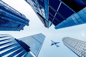 Fototapeta na wymiar Tall buildings and aircraft