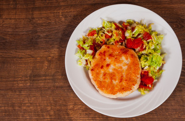 chicken burger with vegetables salad on plate. on wooden table with copy space. top view