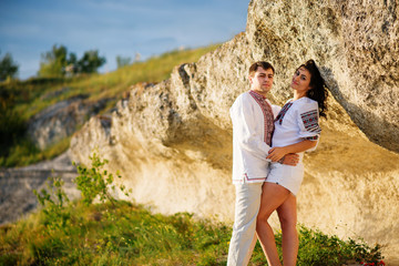 Couple wearing on dress with a pattern at beautiful landscape, o