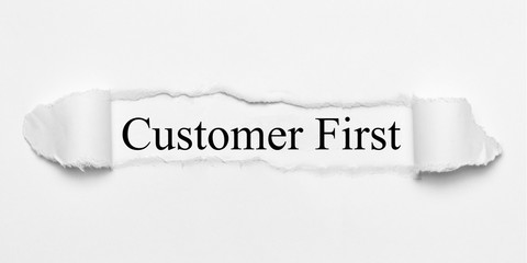 Customer First on white torn paper