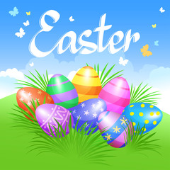 Colorful Easter eggs in green grass for Easter holidays design.