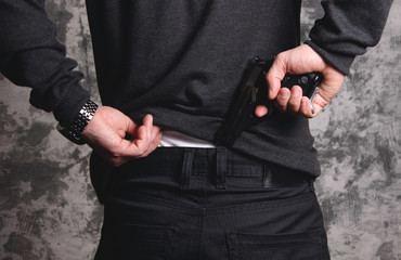 Man taking a gun from his pants