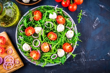 fresh green salad with arugula, tomatoes, mozzarella and red onion