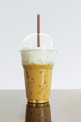 Iced coffee or caffe latte with milk foam in takeaway cup