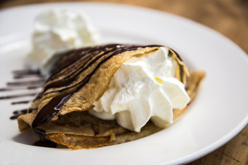 Delicious crepe with cream and chocolate dessert