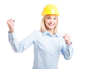 Portrait of smiling female engineer making success gesture